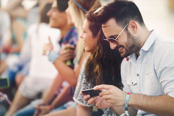 person at a large venue checking phone